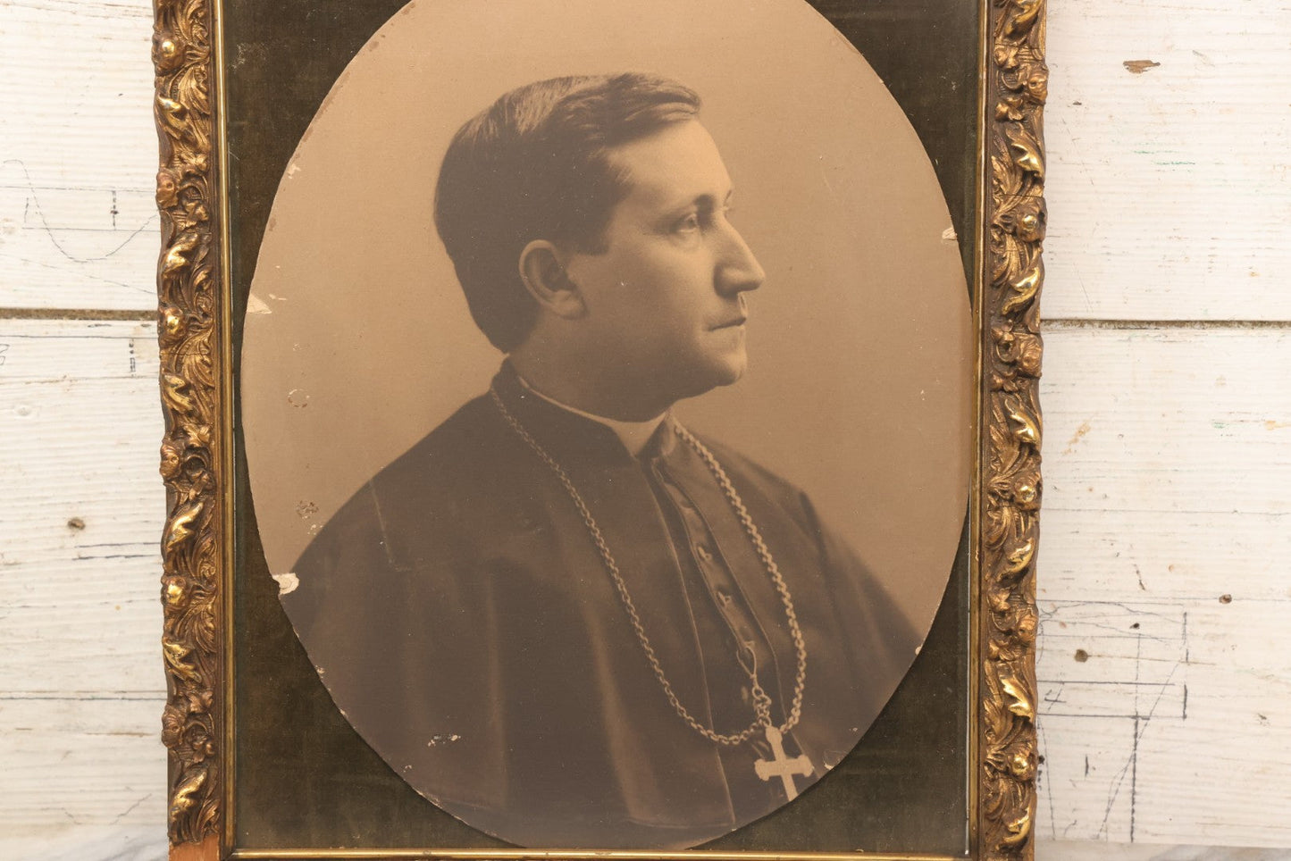 Lot 103 - Antique Oval Black And White Photograph Of Priest In Vestments With Pectoral Crucifix, Circa 1920s In Gilded Moulded Gesso Frame, 13" x 15-3/8"