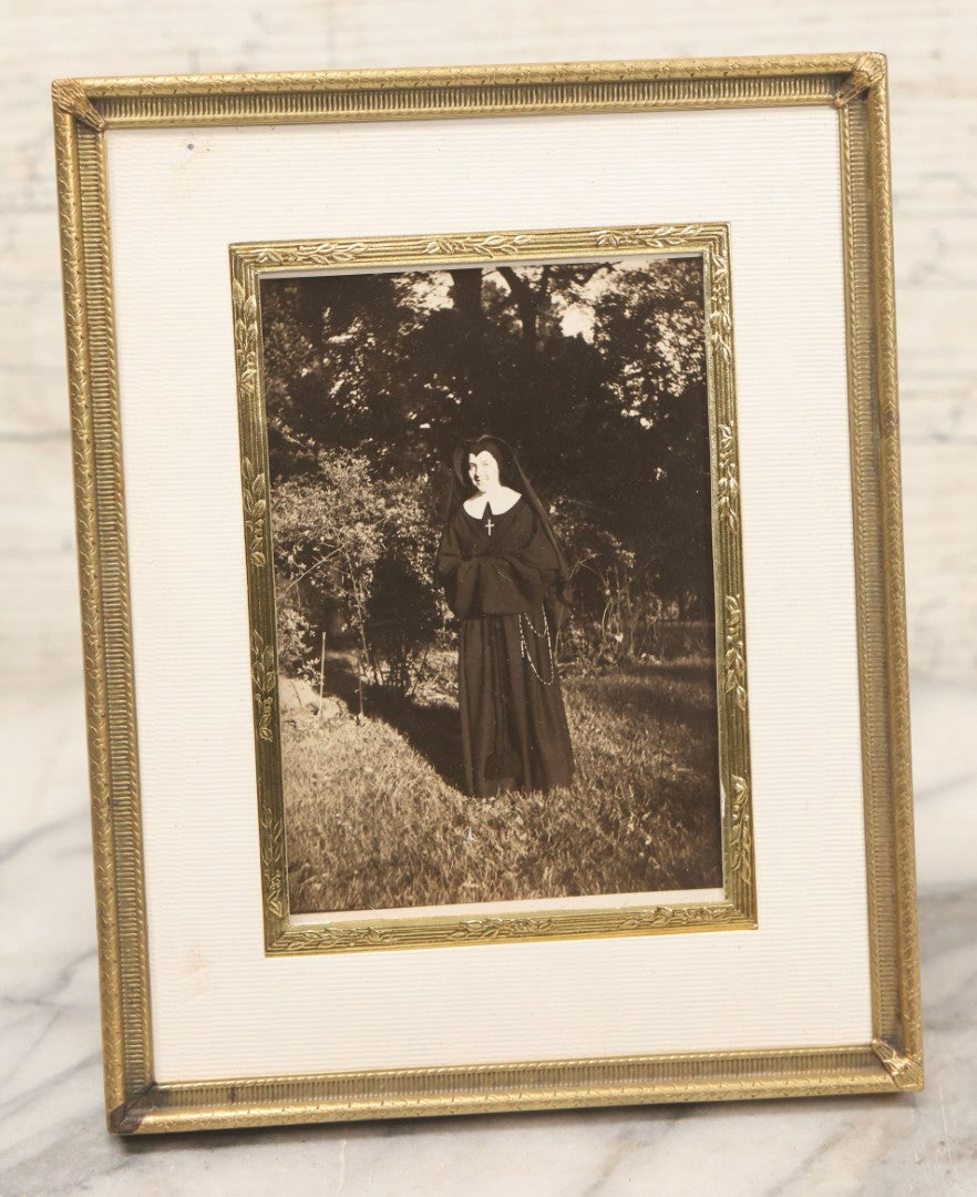 Lot 104 - Vintage Framed Photograph Of Smiling Nun In Backyard, Pressed Brass Frame, 5-1/2" x 6-7/8"