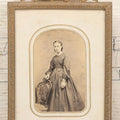 Lot 105 - Antique Carte De Visite C.D.V.. Photograph Of Teenage Girl In Checkered Dress In Brass Tin Frame With Floral Crest And Hanging Loop, 4-3/8" x 6-7/8"