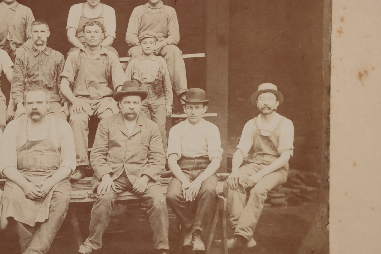 Lot 109 - Antique Boarded Occupational Photograph Of Lumberyard Workers In Work Clothes Posed Atop Stacked Lumber On Sawhorses Before Piles Of Wood