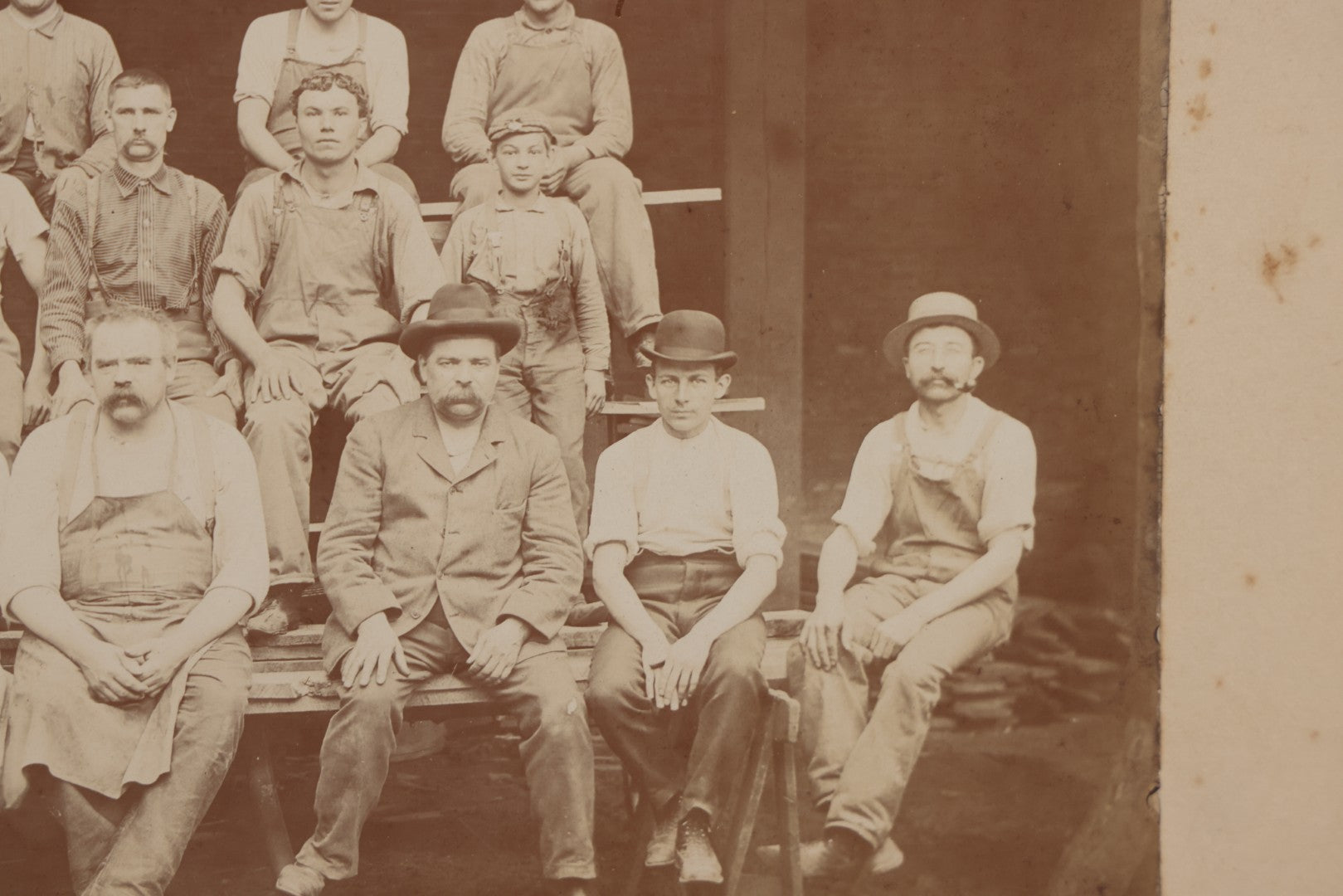 Lot 109 - Antique Boarded Occupational Photograph Of Lumberyard Workers In Work Clothes Posed Atop Stacked Lumber On Sawhorses Before Piles Of Wood