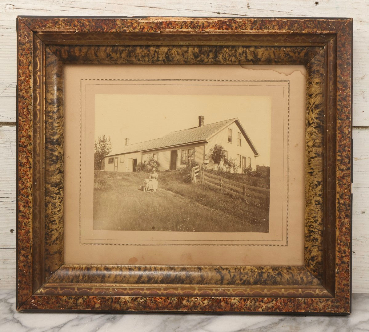Lot 110 - Antique Boarded Photograph Of Woman Seated With Dog Before Farmhouse And Barn, In Faux Marble Painted Double Frame, 15-5/8" x 13-3/4"