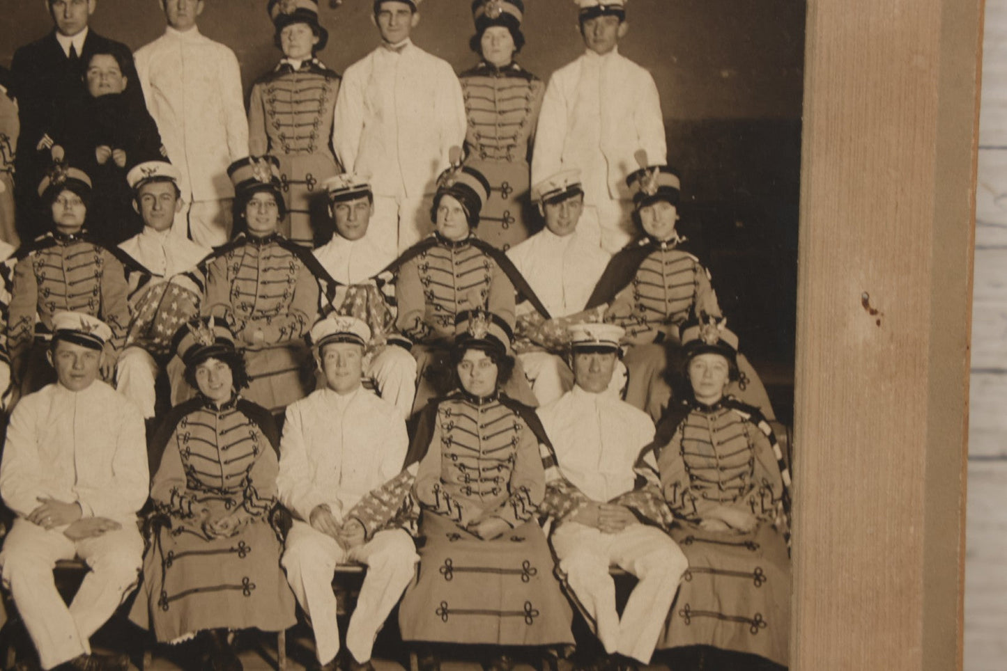 Lot 114 - Antique Boarded Group Photograph Of Men In Sailor Uniforms And Women In Marching Band Outfits