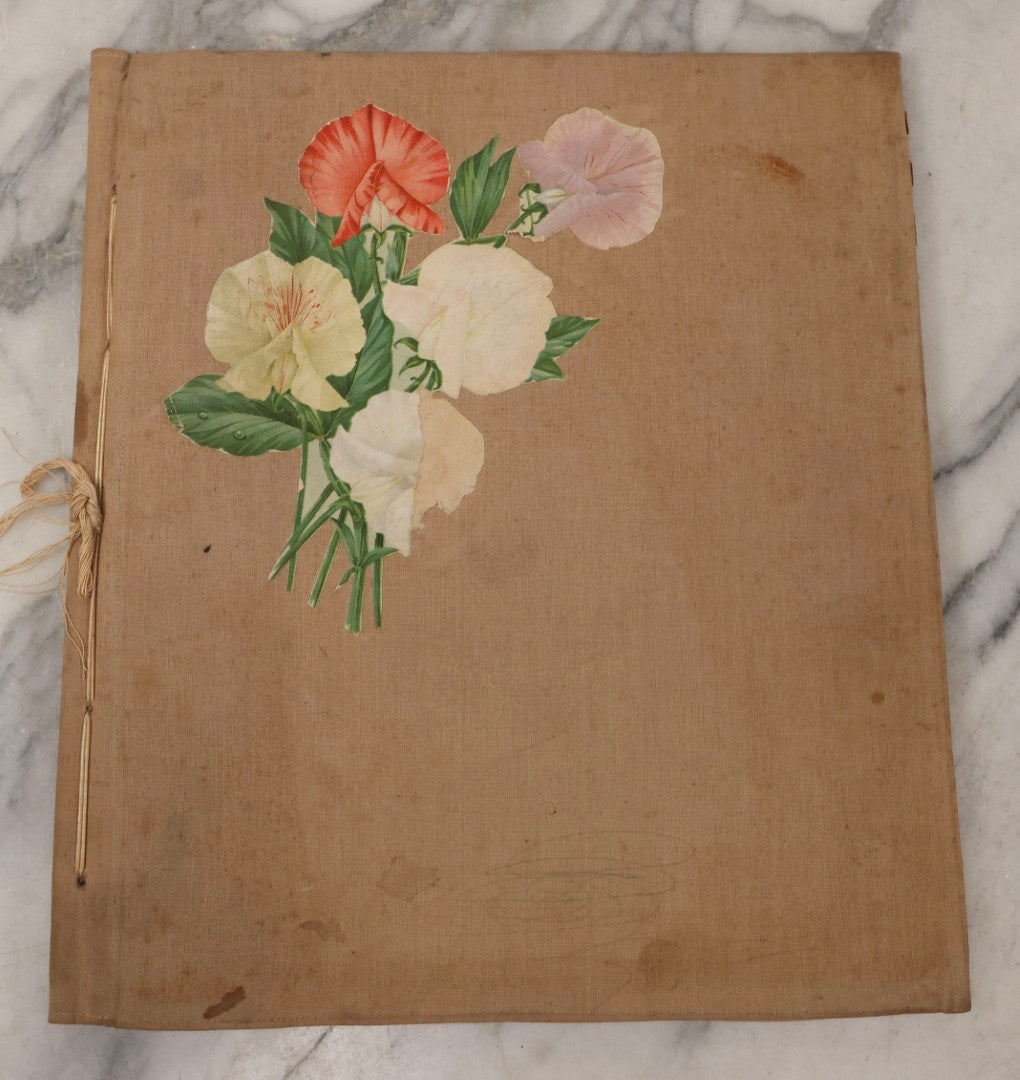 Lot 134 - Antique Linen Scrapbook With Fabric Pages Containing Over 100 Hand Cut Magazine Clippings Including Santa, Children, Animals, Kewpies, Women, Advertisements, And More Circa 1913