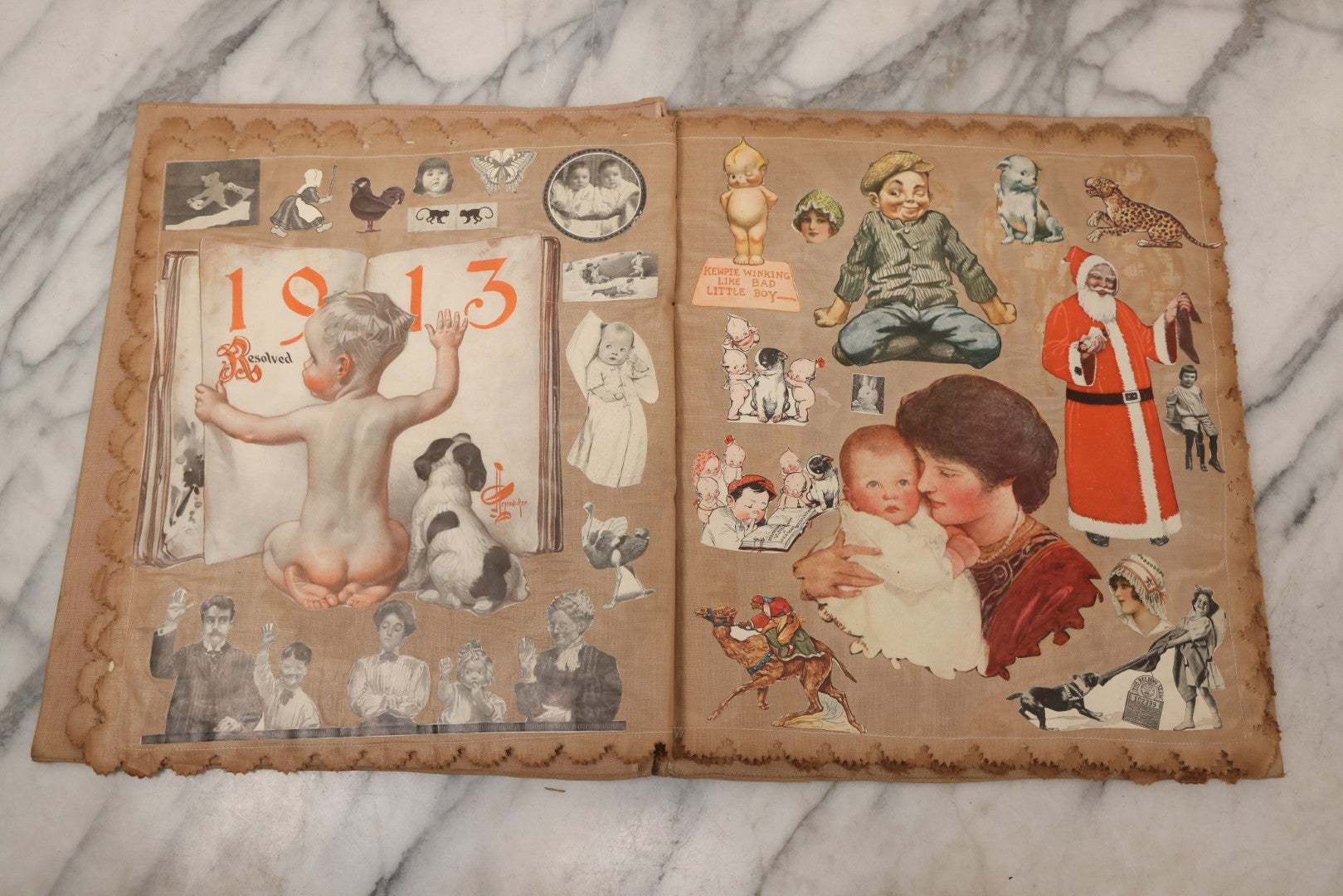 Lot 134 - Antique Linen Scrapbook With Fabric Pages Containing Over 100 Hand Cut Magazine Clippings Including Santa, Children, Animals, Kewpies, Women, Advertisements, And More Circa 1913