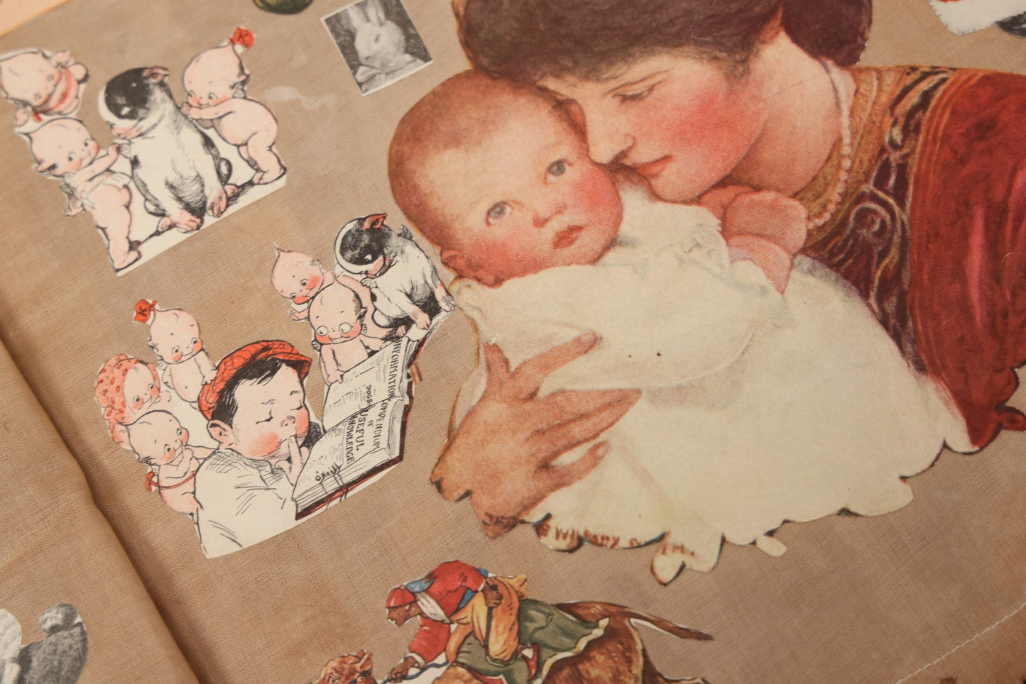 Lot 134 - Antique Linen Scrapbook With Fabric Pages Containing Over 100 Hand Cut Magazine Clippings Including Santa, Children, Animals, Kewpies, Women, Advertisements, And More Circa 1913