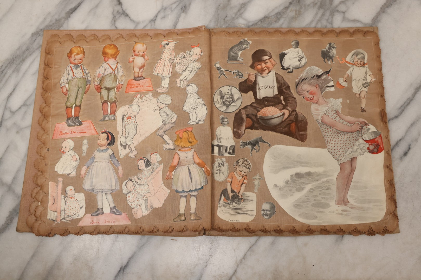 Lot 134 - Antique Linen Scrapbook With Fabric Pages Containing Over 100 Hand Cut Magazine Clippings Including Santa, Children, Animals, Kewpies, Women, Advertisements, And More Circa 1913