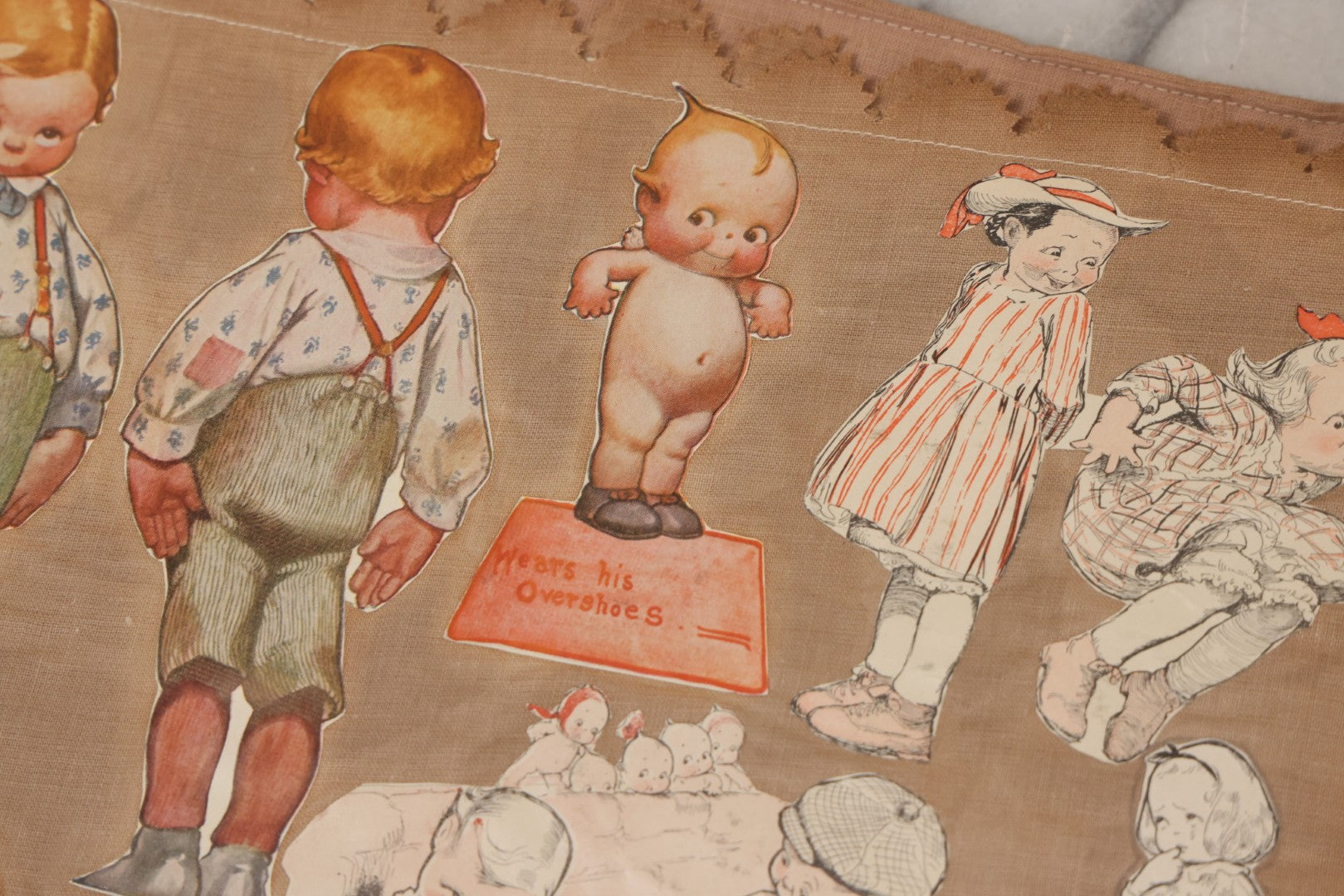 Lot 134 - Antique Linen Scrapbook With Fabric Pages Containing Over 100 Hand Cut Magazine Clippings Including Santa, Children, Animals, Kewpies, Women, Advertisements, And More Circa 1913