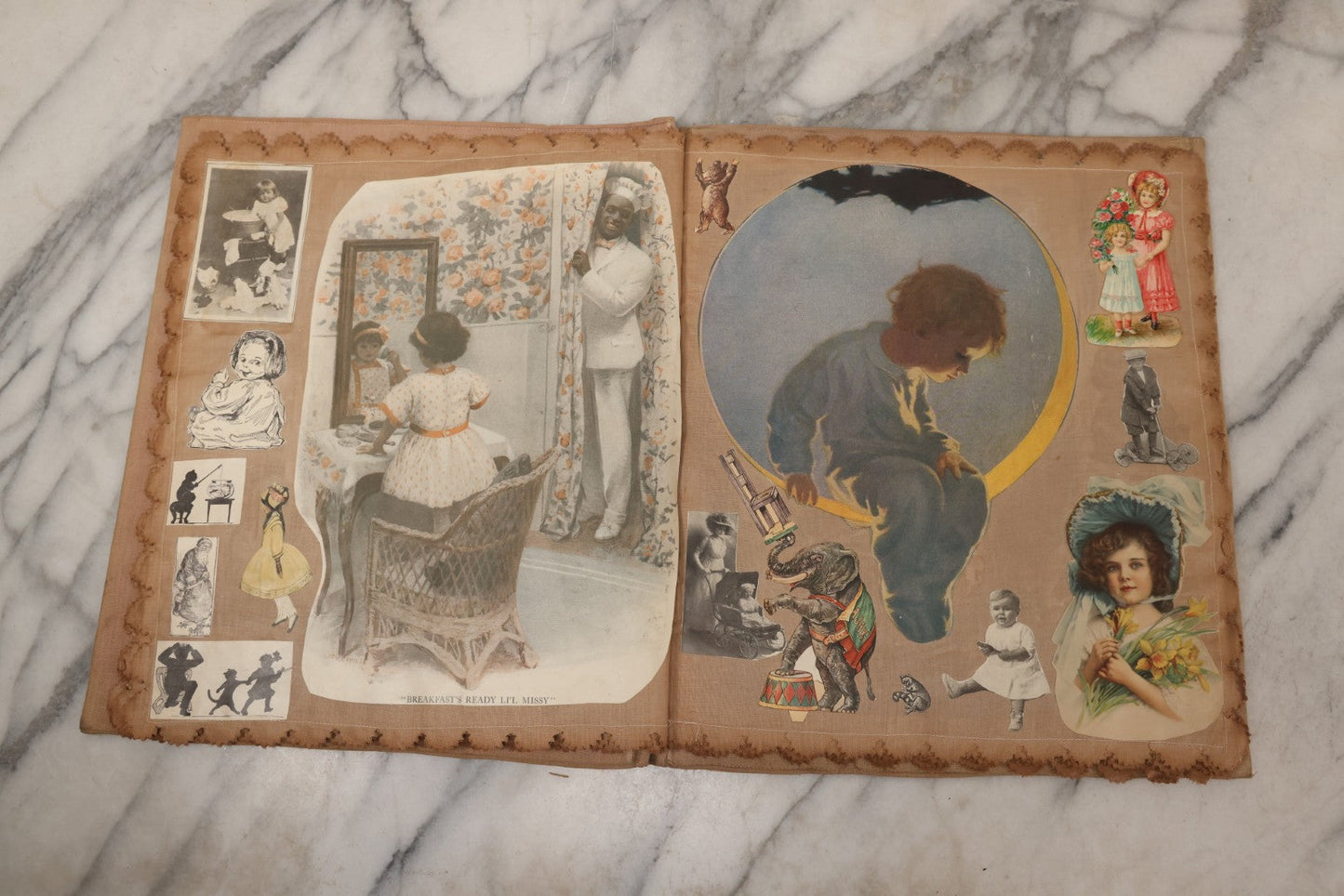 Lot 134 - Antique Linen Scrapbook With Fabric Pages Containing Over 100 Hand Cut Magazine Clippings Including Santa, Children, Animals, Kewpies, Women, Advertisements, And More Circa 1913