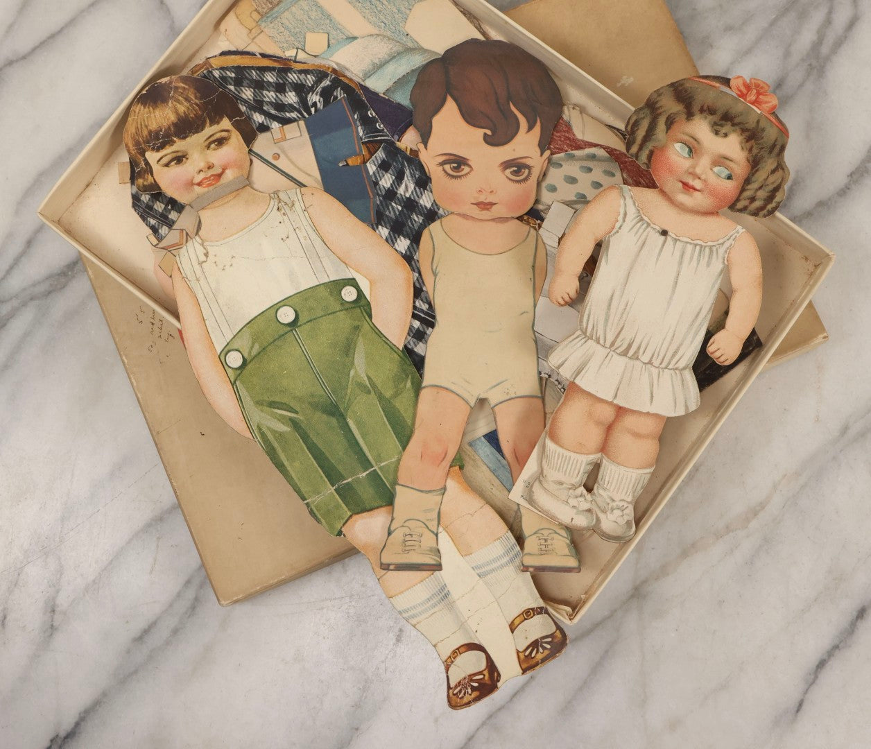 Lot 136 - Antique Box Lot Of Paper Dolls And Clothing, Including Hand Drawn Outfits And Mechanical "Susan" Doll By Sam'L Gabriel Sons & Company, Printed In Germany, 1919