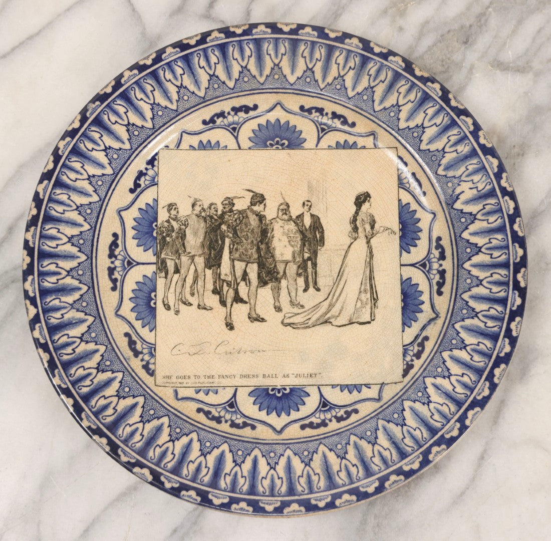Lot 153 - Pair Of Antique Royal Doulton Decorative Plates With Life Publishing Co. Scenes By Charles Dana Gibson, 1900–1901, Including "They Go Fishing" And "She Goes To The Fancy Dress Ball As 'Juliet'," 10-1/2" Diameter Each