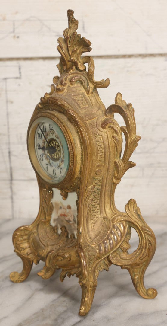 Lot 012 - Antique Waterbury Clock Co. Gold-Painted Spelter Mantel Clock With Hand-Painted Dial And Cupid Scene Panel, Circa 1890s Working Condition, 11" H