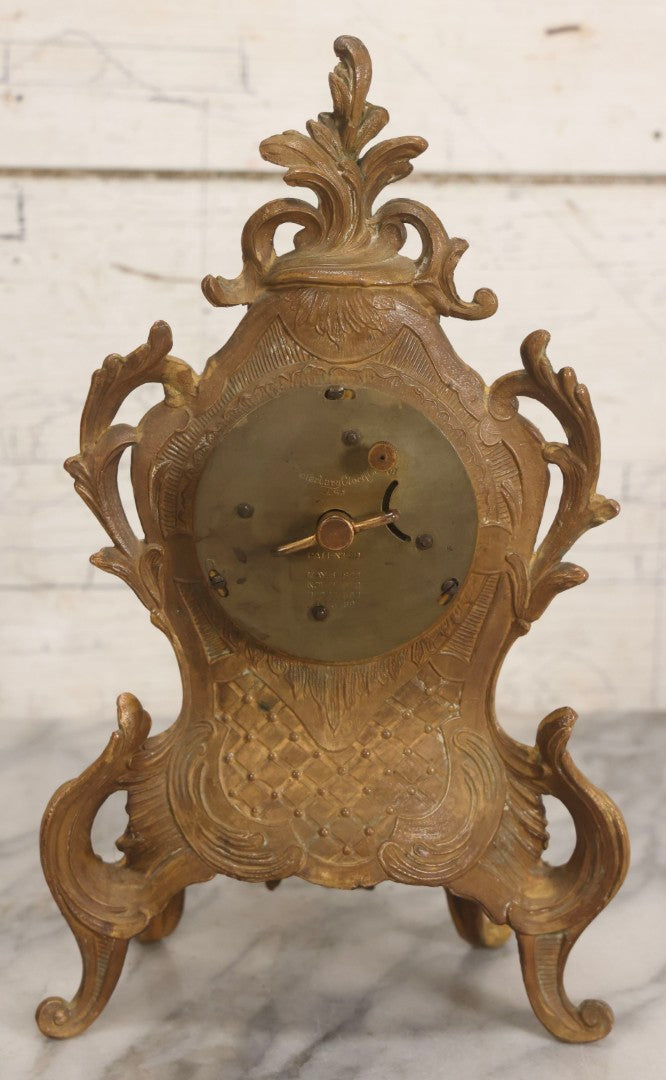Lot 012 - Antique Waterbury Clock Co. Gold-Painted Spelter Mantel Clock With Hand-Painted Dial And Cupid Scene Panel, Circa 1890s Working Condition, 11" H