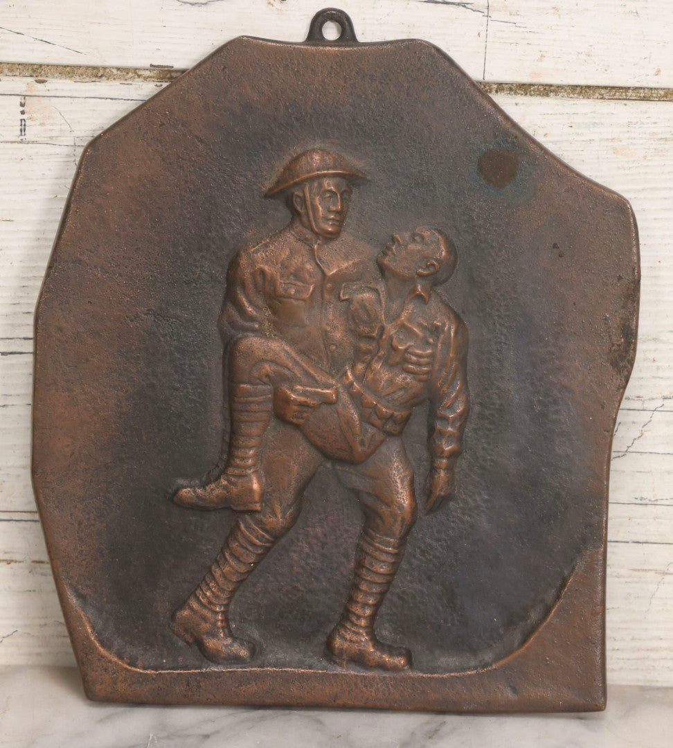 Lot 015 - Antique Bronze-Finished Metal Relief Plaque Depicting WWI Soldier Carrying Fallen Comrade, With Hanging Ring, 8-1/4" x 9-5/8"