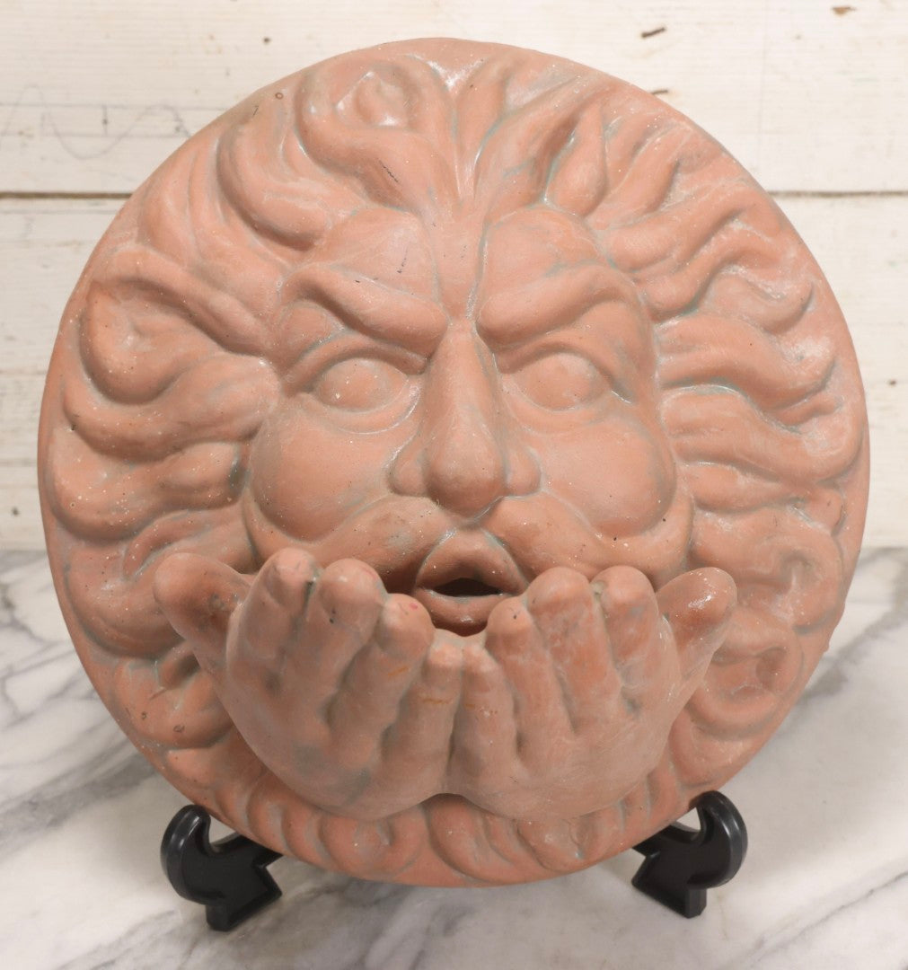 Lot 020 - Vintage Unglazed Ceramic Greenman Wall Plaque With Relief Face Blowing Over Pair Of Hands, Cold-Painted Surface, Marked "B P" On Verso, 13-3/4" Diameter