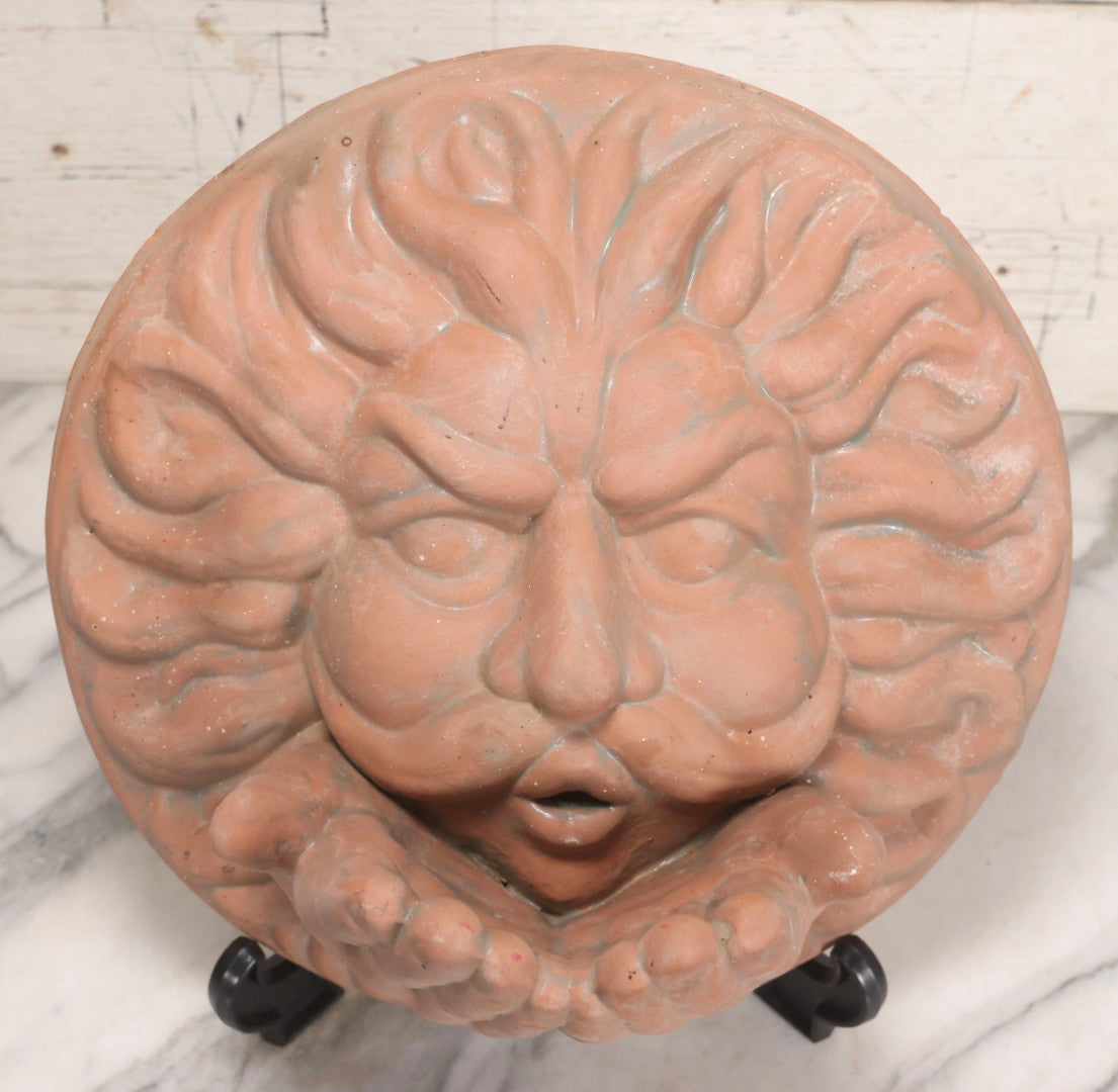 Lot 020 - Vintage Unglazed Ceramic Greenman Wall Plaque With Relief Face Blowing Over Pair Of Hands, Cold-Painted Surface, Marked "B P" On Verso, 13-3/4" Diameter
