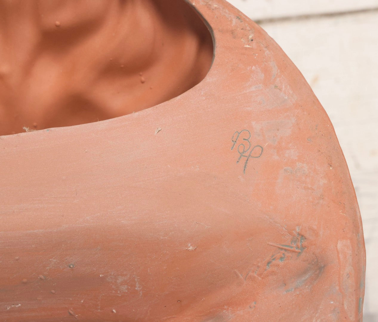 Lot 020 - Vintage Unglazed Ceramic Greenman Wall Plaque With Relief Face Blowing Over Pair Of Hands, Cold-Painted Surface, Marked "B P" On Verso, 13-3/4" Diameter