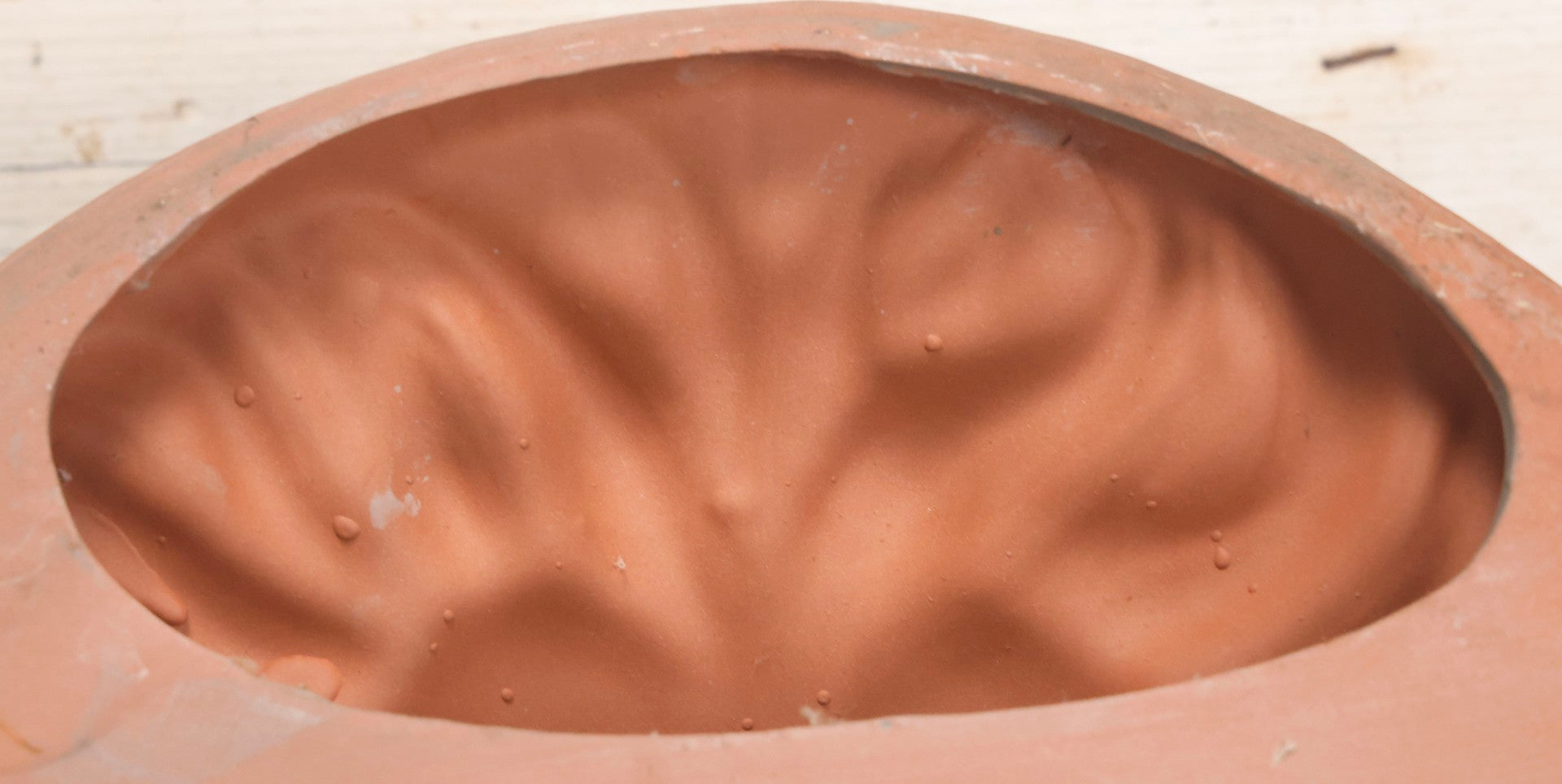 Lot 020 - Vintage Unglazed Ceramic Greenman Wall Plaque With Relief Face Blowing Over Pair Of Hands, Cold-Painted Surface, Marked "B P" On Verso, 13-3/4" Diameter