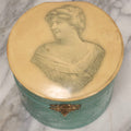 Lot 028 - Antique Blue-Green And White Celluloid Collar Box With Printed Portrait Of Woman, Pink Fabric Lining, And Arrow Cluett Peabody & Co. Collar, 6" H