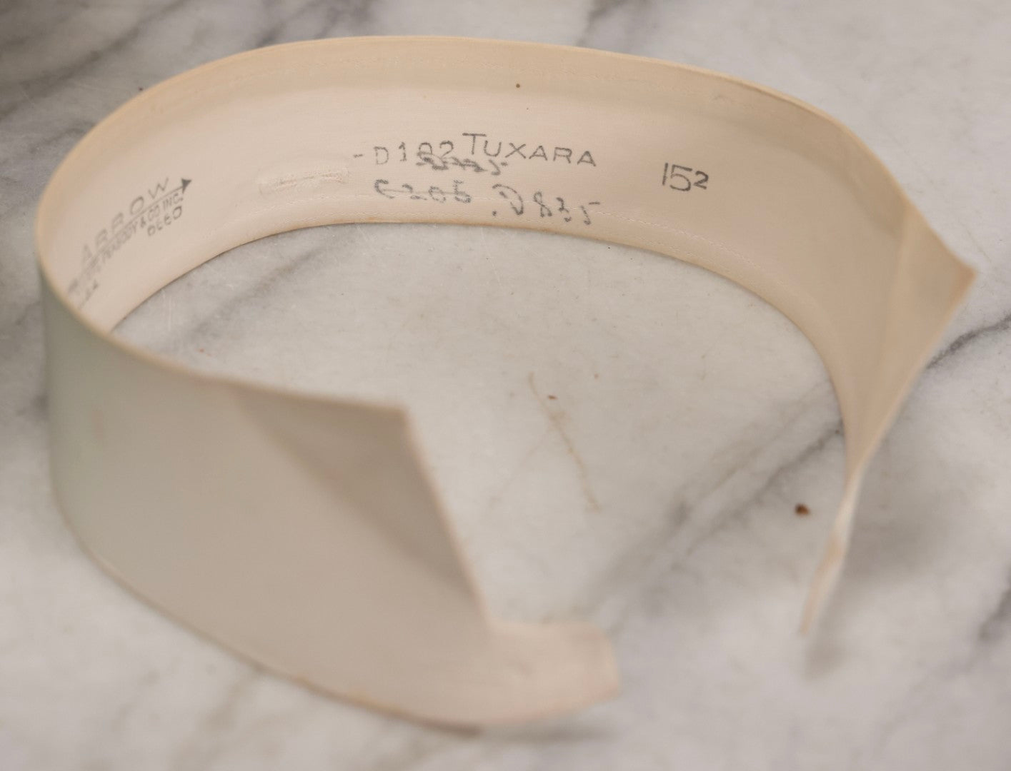 Lot 028 - Antique Blue-Green And White Celluloid Collar Box With Printed Portrait Of Woman, Pink Fabric Lining, And Arrow Cluett Peabody & Co. Collar, 6" H