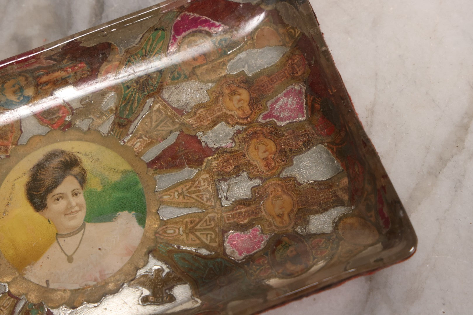 Lot 031 - Antique Reverse Painted And Collaged Cigar Bands Glass Tray With Portrait Of Woman And Red Felt Backing, 8-7/8" x 5"