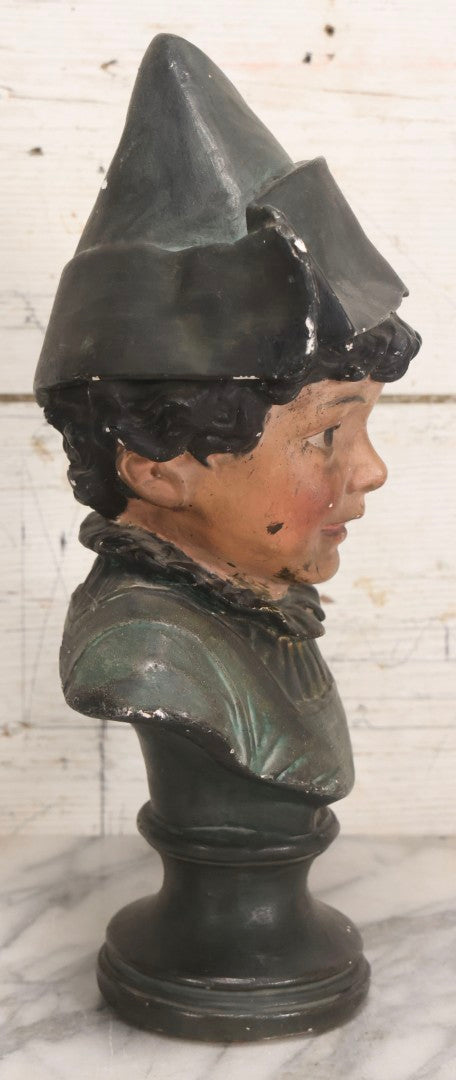 Lot 032 - Antique Hand Painted Chalkware Bust Of Boy In Green Ruffle Collared Shirt And Folded Paper Style Hat With Black Band And Green Top, 15" H