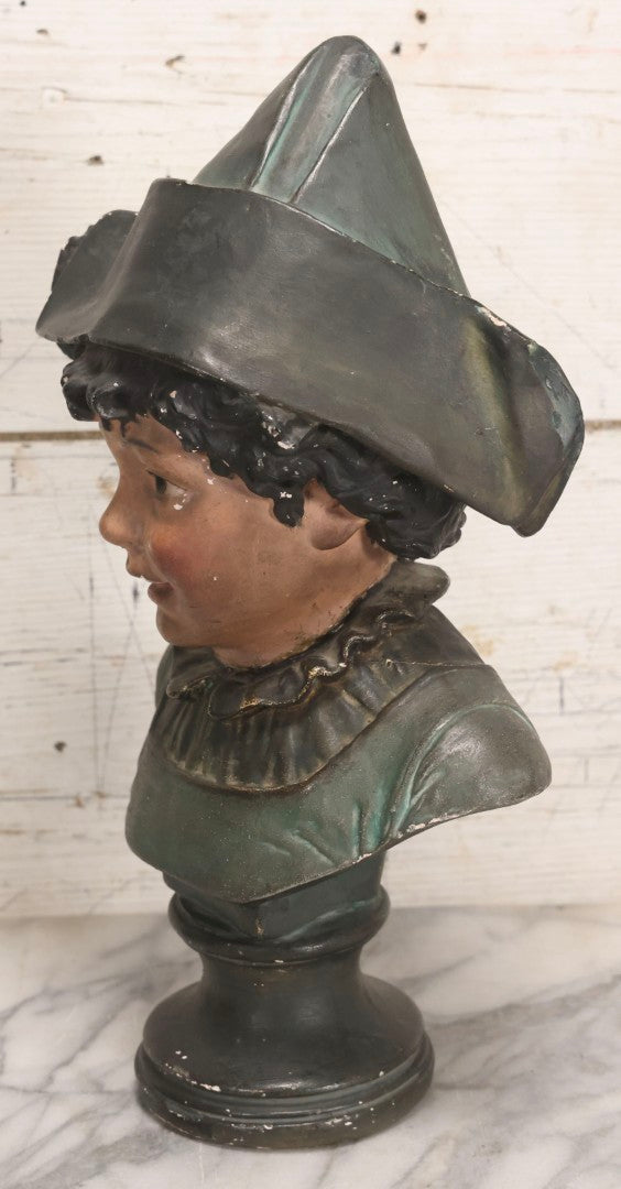Lot 032 - Antique Hand Painted Chalkware Bust Of Boy In Green Ruffle Collared Shirt And Folded Paper Style Hat With Black Band And Green Top, 15" H