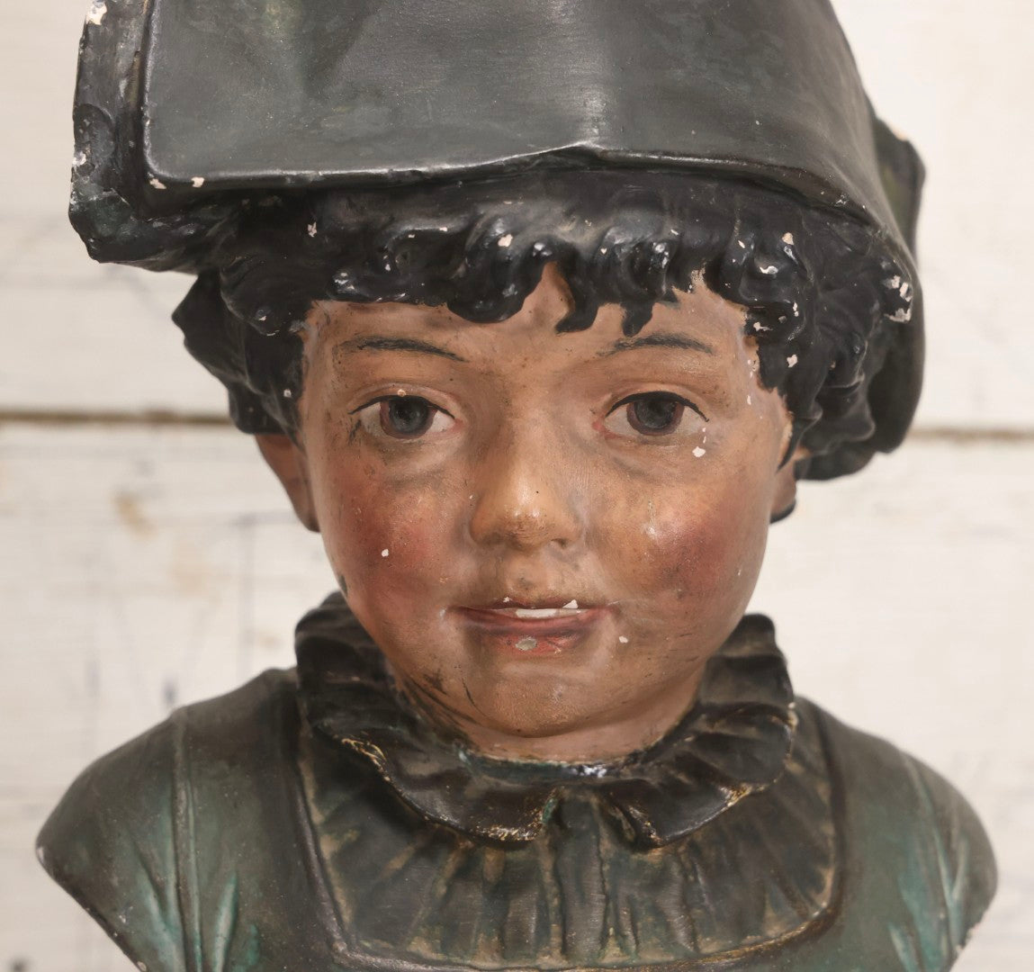 Lot 032 - Antique Hand Painted Chalkware Bust Of Boy In Green Ruffle Collared Shirt And Folded Paper Style Hat With Black Band And Green Top, 15" H