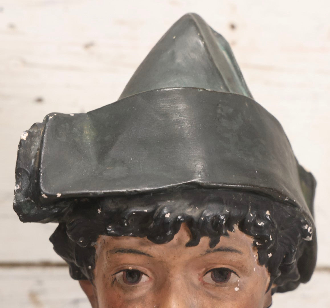 Lot 032 - Antique Hand Painted Chalkware Bust Of Boy In Green Ruffle Collared Shirt And Folded Paper Style Hat With Black Band And Green Top, 15" H