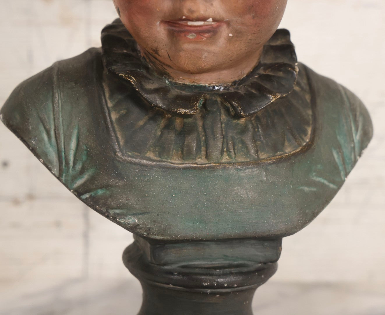 Lot 032 - Antique Hand Painted Chalkware Bust Of Boy In Green Ruffle Collared Shirt And Folded Paper Style Hat With Black Band And Green Top, 15" H