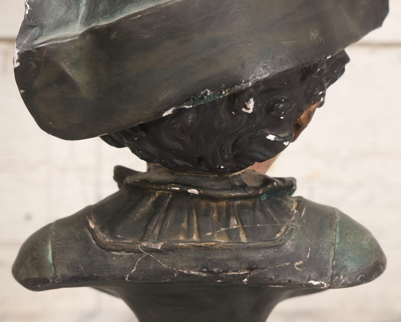 Lot 032 - Antique Hand Painted Chalkware Bust Of Boy In Green Ruffle Collared Shirt And Folded Paper Style Hat With Black Band And Green Top, 15" H