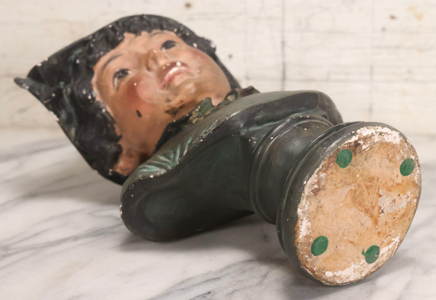 Lot 032 - Antique Hand Painted Chalkware Bust Of Boy In Green Ruffle Collared Shirt And Folded Paper Style Hat With Black Band And Green Top, 15" H