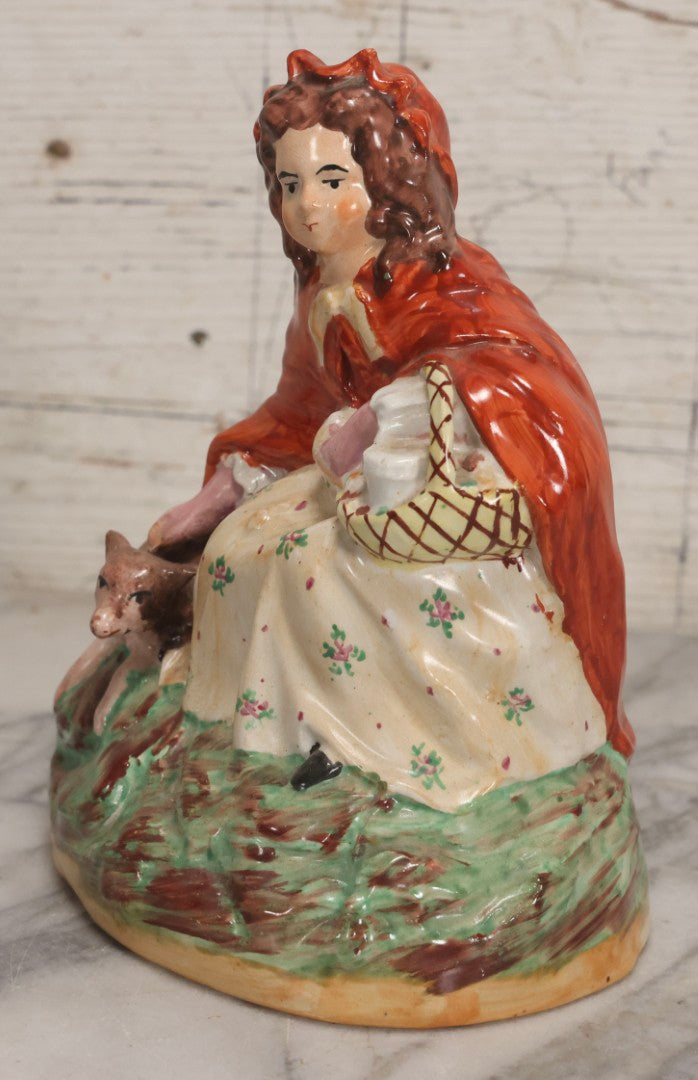 Lot 036 - Antique Staffordshire Porcelain Figure Of Girl In Red Hood With Basket And Dog, Possibly Little Red Riding Hood, 7-1/2" H