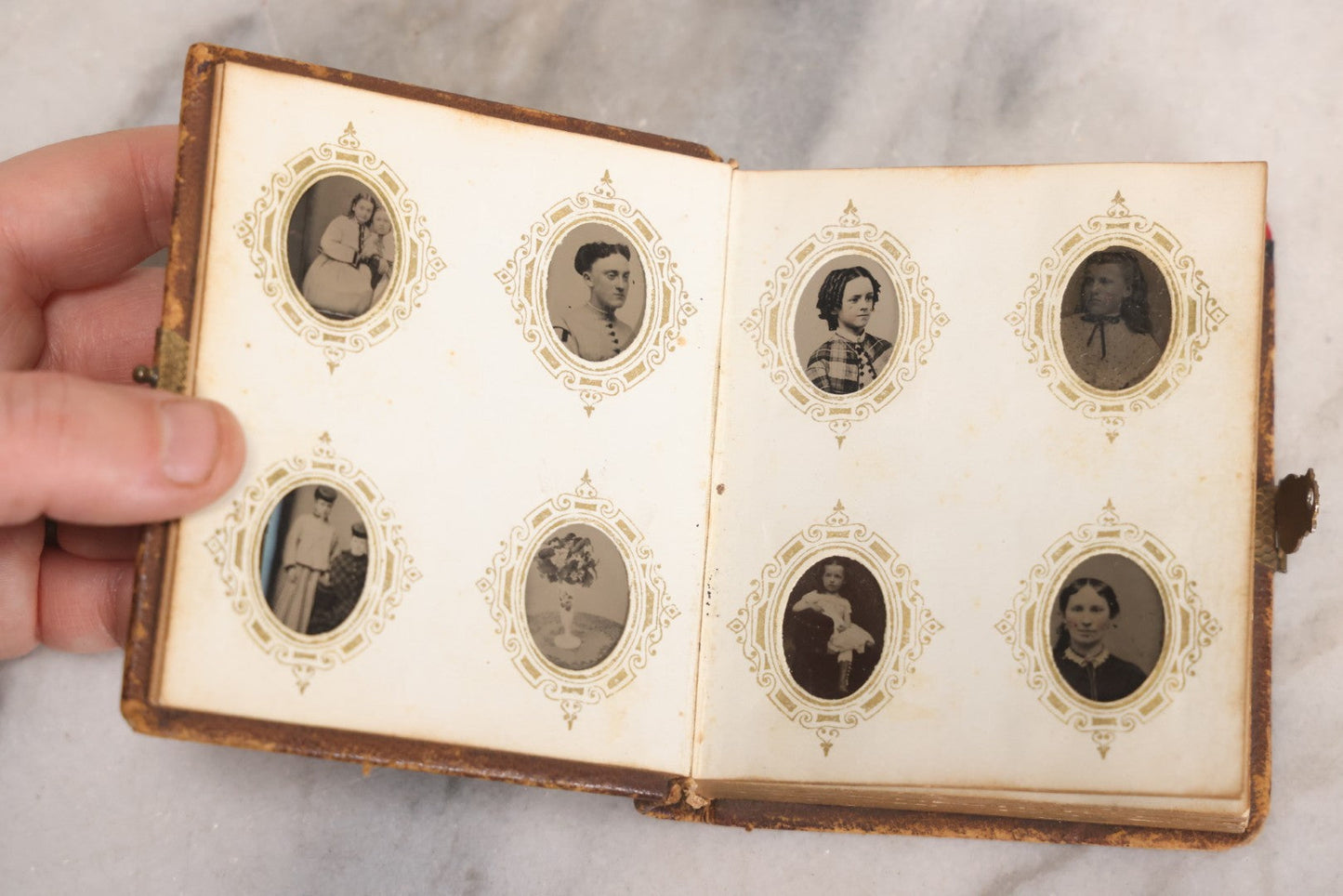 Lot 041 - Antique Complete Gem Tintype Photo Album Containing 96 Images On 12 Double-Sided Pages, Including Boy With Dog, Group And Pair Portraits, And Finely Executed Individual Studies
