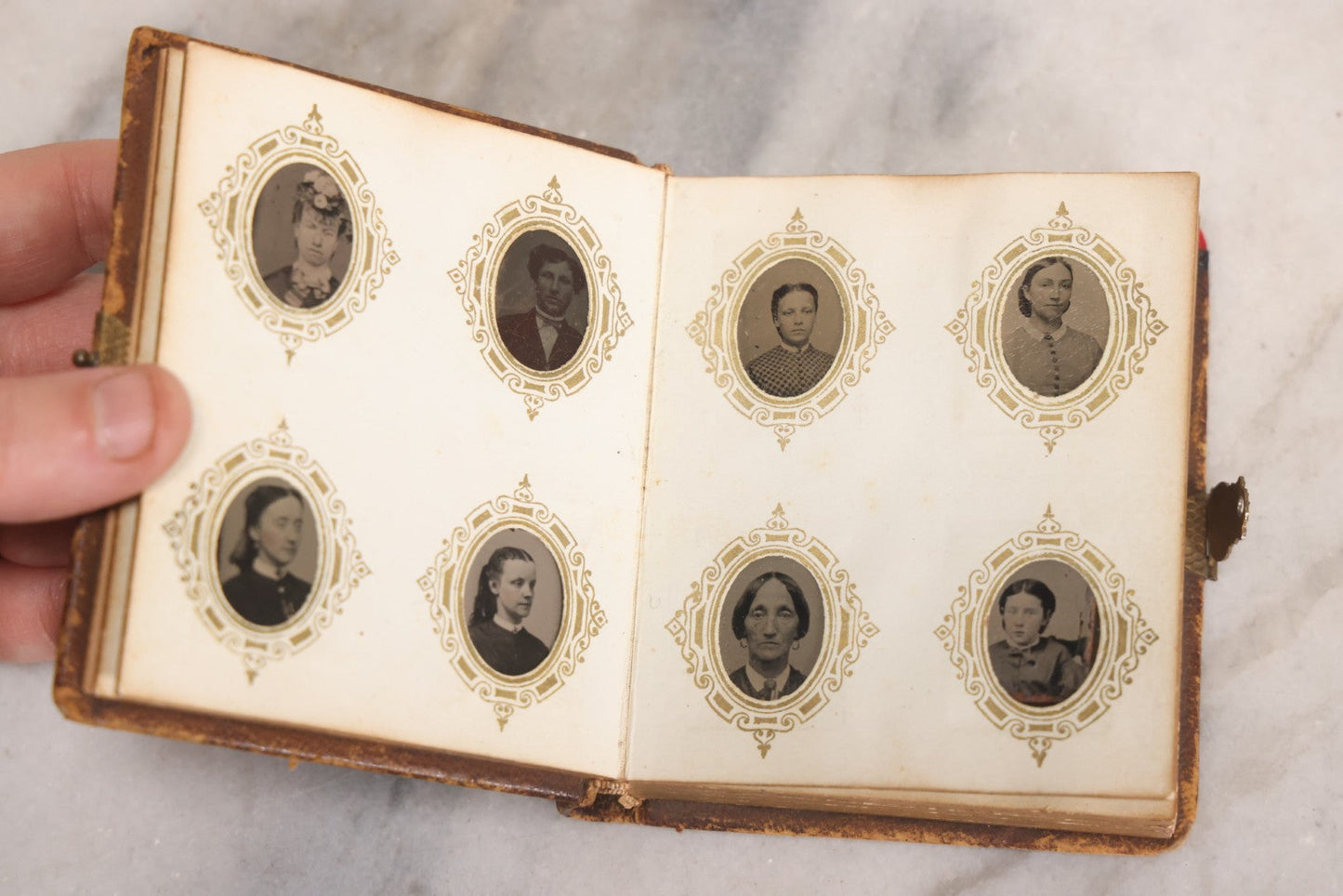 Lot 041 - Antique Complete Gem Tintype Photo Album Containing 96 Images On 12 Double-Sided Pages, Including Boy With Dog, Group And Pair Portraits, And Finely Executed Individual Studies