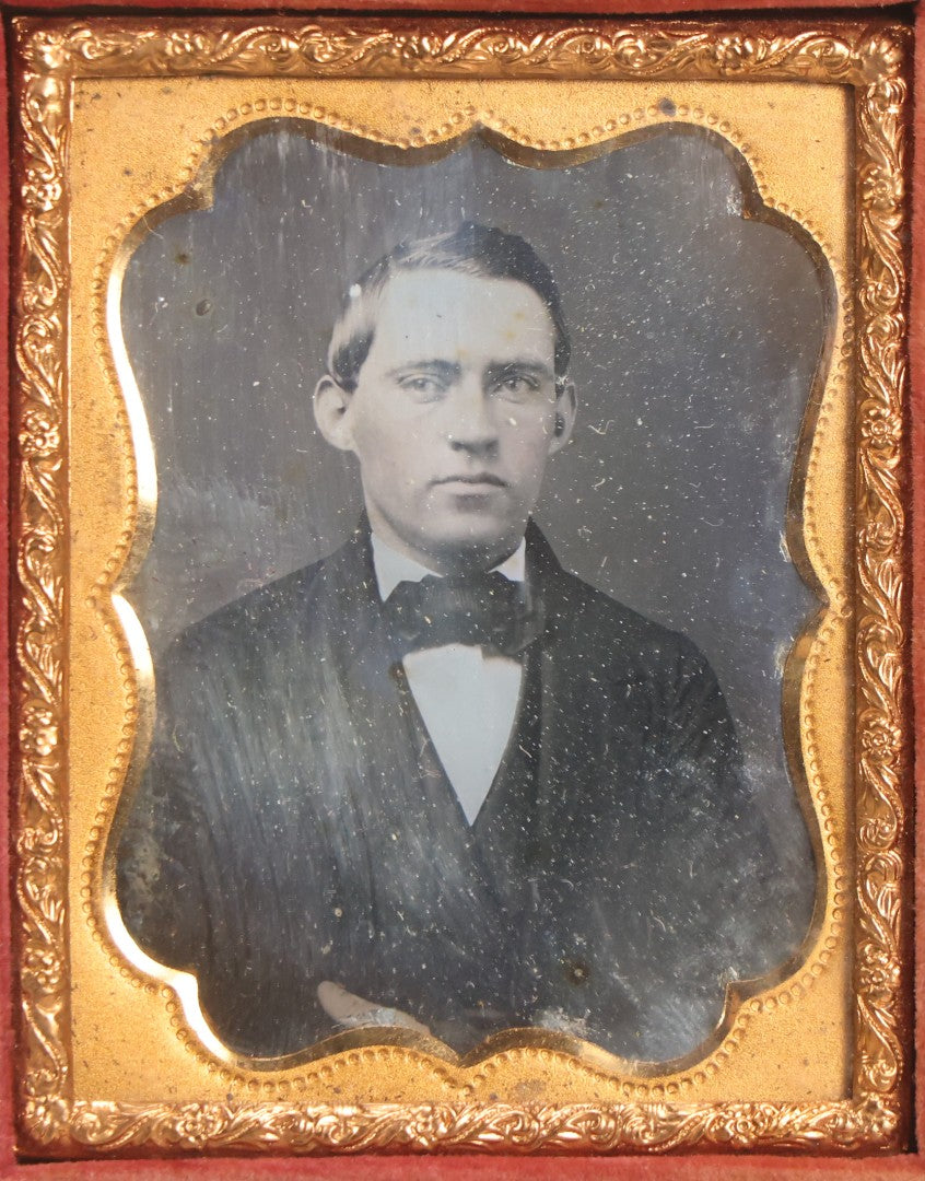 Lot 045 - Antique 1/9th Plate Daguerreotype Photograph Of Young Man In Bowtie, In Full Split Leatherette Union Case