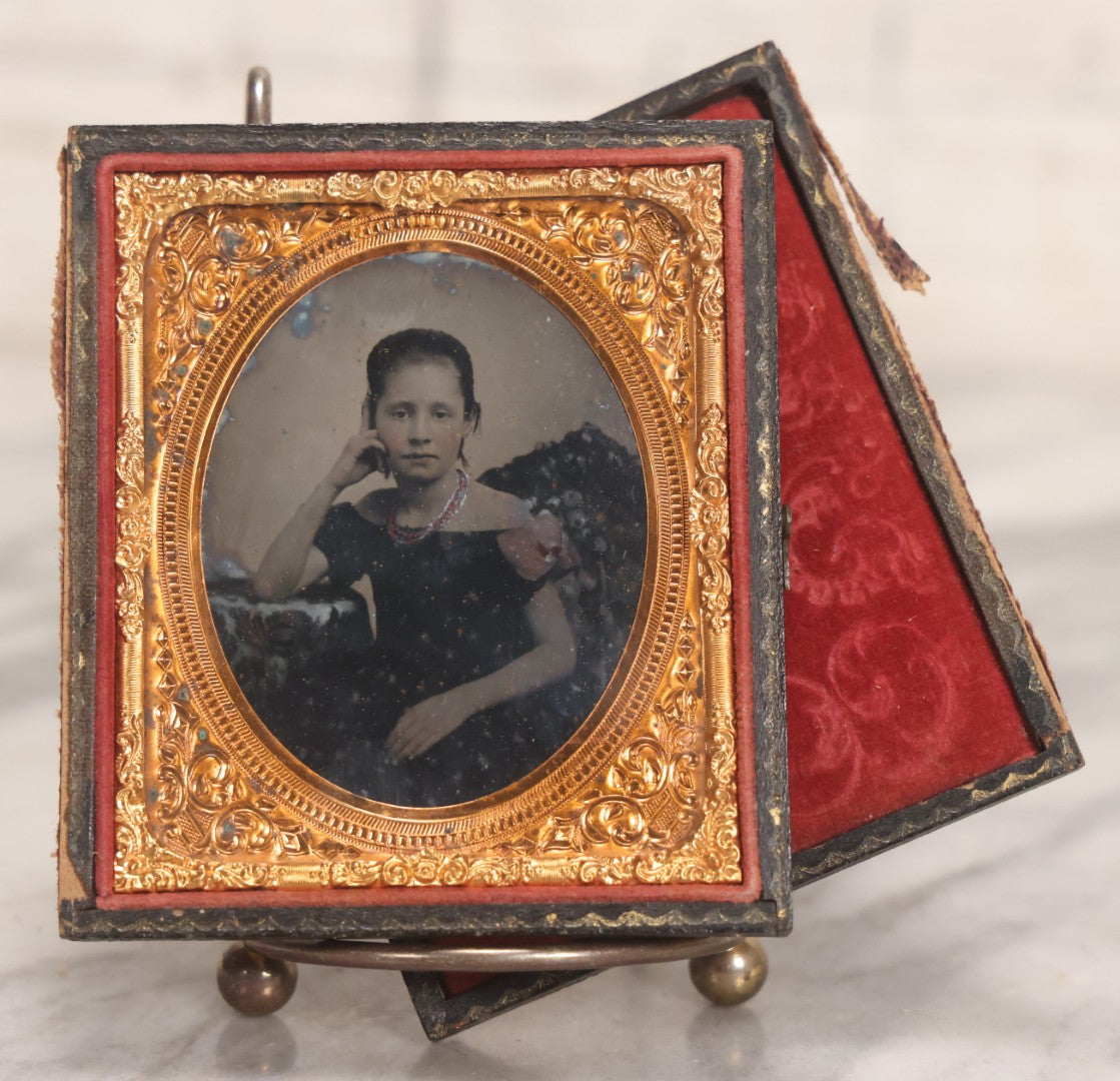 Lot 046 - Antique 1/6th Plate Ruby Ambrotype Photograph Of Pretty Young Girl In Off-Shoulder Dress With Jewelry, Posed Resting Hand Against Head, In Full Split Leatherette Union Case