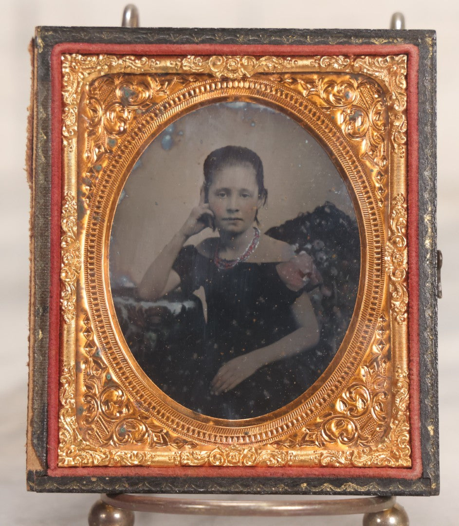 Lot 046 - Antique 1/6th Plate Ruby Ambrotype Photograph Of Pretty Young Girl In Off-Shoulder Dress With Jewelry, Posed Resting Hand Against Head, In Full Split Leatherette Union Case