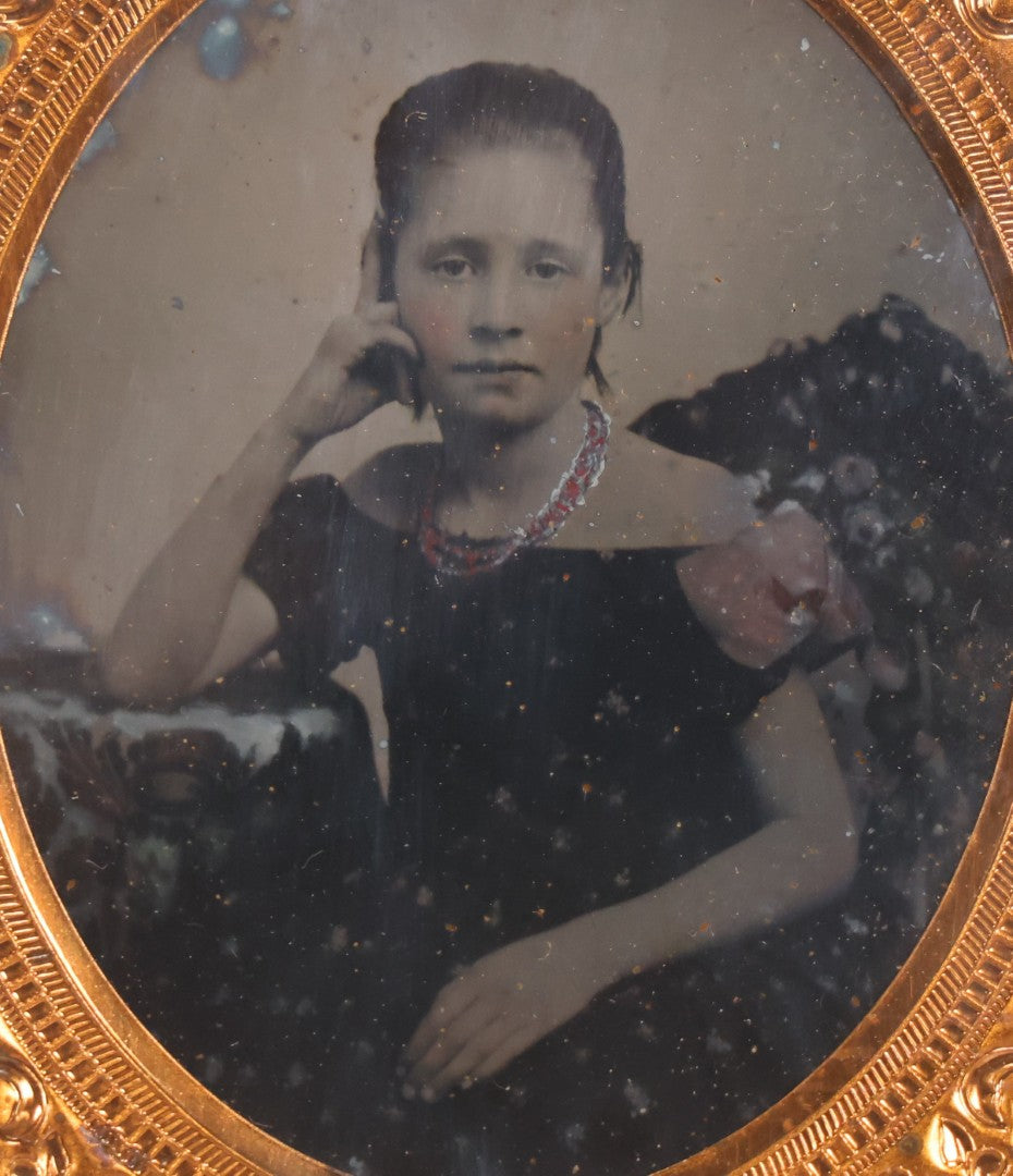 Lot 046 - Antique 1/6th Plate Ruby Ambrotype Photograph Of Pretty Young Girl In Off-Shoulder Dress With Jewelry, Posed Resting Hand Against Head, In Full Split Leatherette Union Case