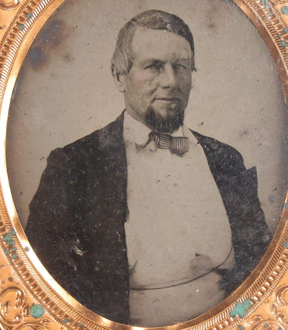 Lot 048 - Antique 1/6th Plate Ruby Ambrotype Photograph Of Skeptical-Looking Middle-Aged Man In Bowtie, White Shirt, And Blazer, In Half Leatherette Union Case