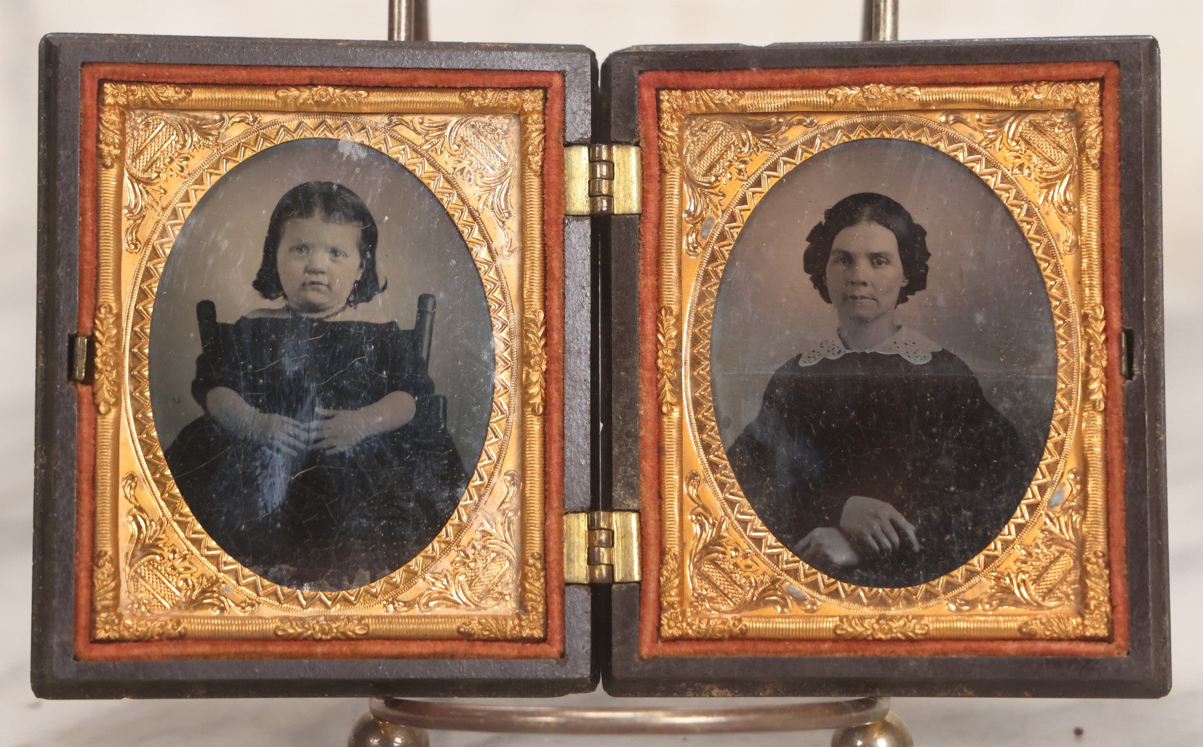 Lot 051 - Pair Of Antique 1/9th Plate Ruby Ambrotype Photographs Of Chubby Young Girl And Older Woman, Possibly Mother And Daughter, In Littlefield, Parsons & Co. Double Thermoplastic Union Case Patented 1856–1857, Note Crack To One Image