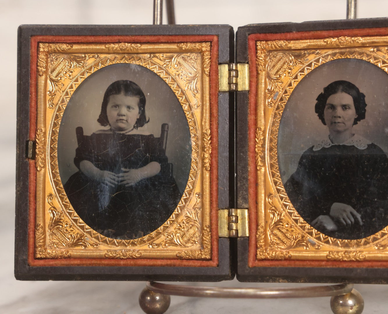 Lot 051 - Pair Of Antique 1/9th Plate Ruby Ambrotype Photographs Of Chubby Young Girl And Older Woman, Possibly Mother And Daughter, In Littlefield, Parsons & Co. Double Thermoplastic Union Case Patented 1856–1857, Note Crack To One Image
