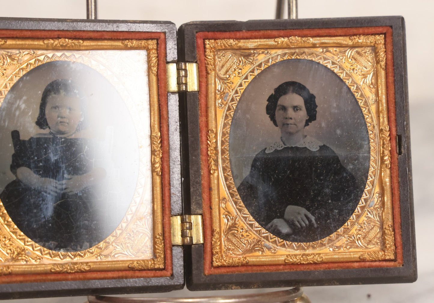 Lot 051 - Pair Of Antique 1/9th Plate Ruby Ambrotype Photographs Of Chubby Young Girl And Older Woman, Possibly Mother And Daughter, In Littlefield, Parsons & Co. Double Thermoplastic Union Case Patented 1856–1857, Note Crack To One Image