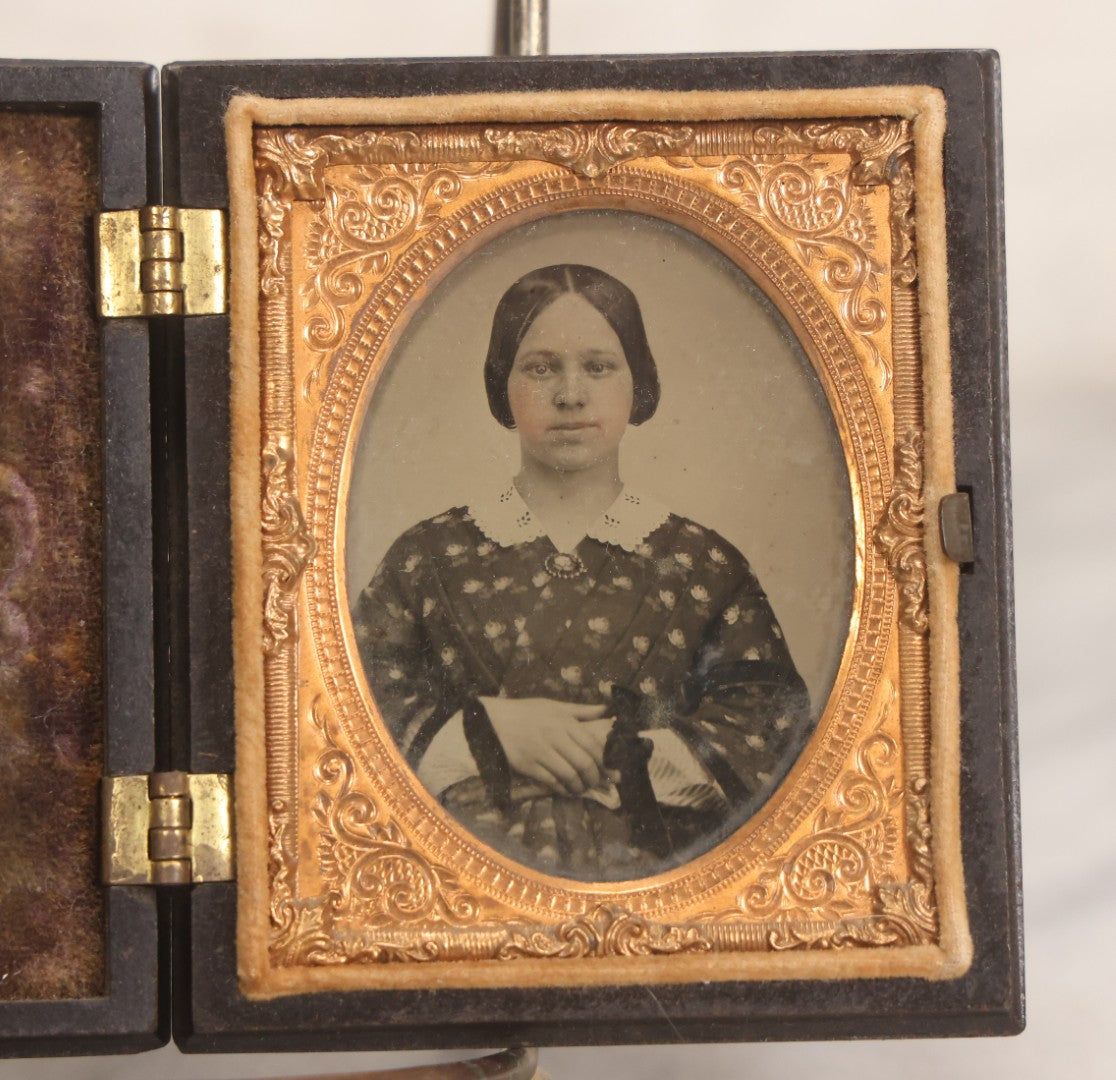 Lot 052 - Antique 1/9th Plate Ambrotype Photograph Of Young Woman In Flower-Patterned Dress In Thermoplastic Union Case Patented By S. Peck 1854 And H. Halverson 1855