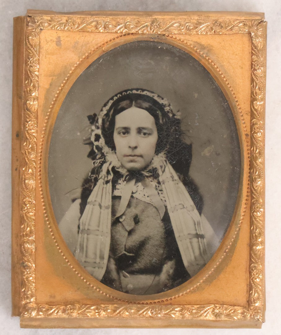 Lot 053 - Antique 1/9th Plate Ruby Ambrotype Photograph Of Pretty Young Woman In Elaborate Bonnet And Coat With Long Bonnet Ties Draped Across Chest, Uncased With Brass Mat And Preserver