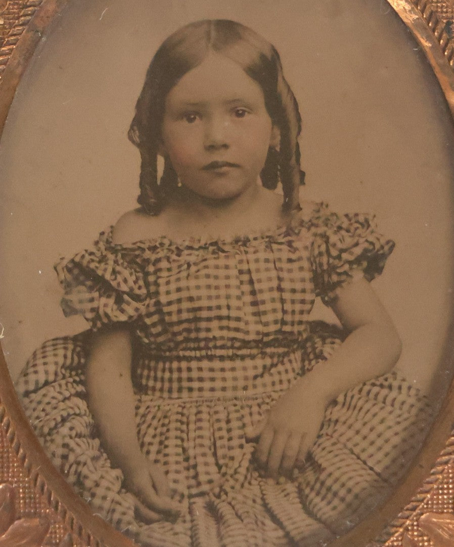 Lot 054 - Antique 1/9th Plate Ruby Ambrotype Photograph Of Pretty Young Girl With Blonde Curls In Checkered Off-Shoulder Dress, Uncased With Brass Mat And Preserver