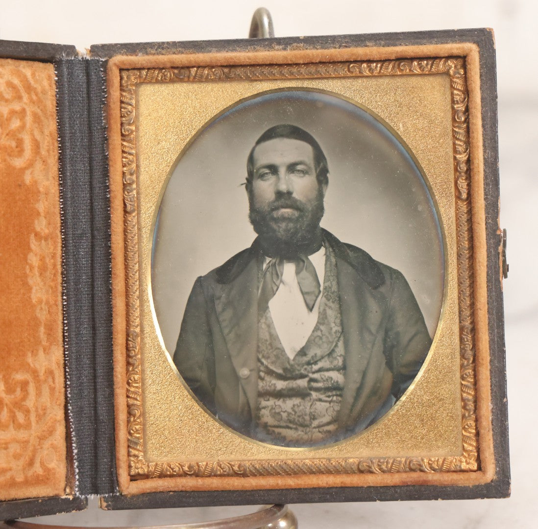 Lot 057 - Antique 1/6th Plate Ambrotype Photograph Of Bearded Man In Silk Neck Tie And Formal Dress, In Full Leatherette Union Case Repaired With Tape Hinge