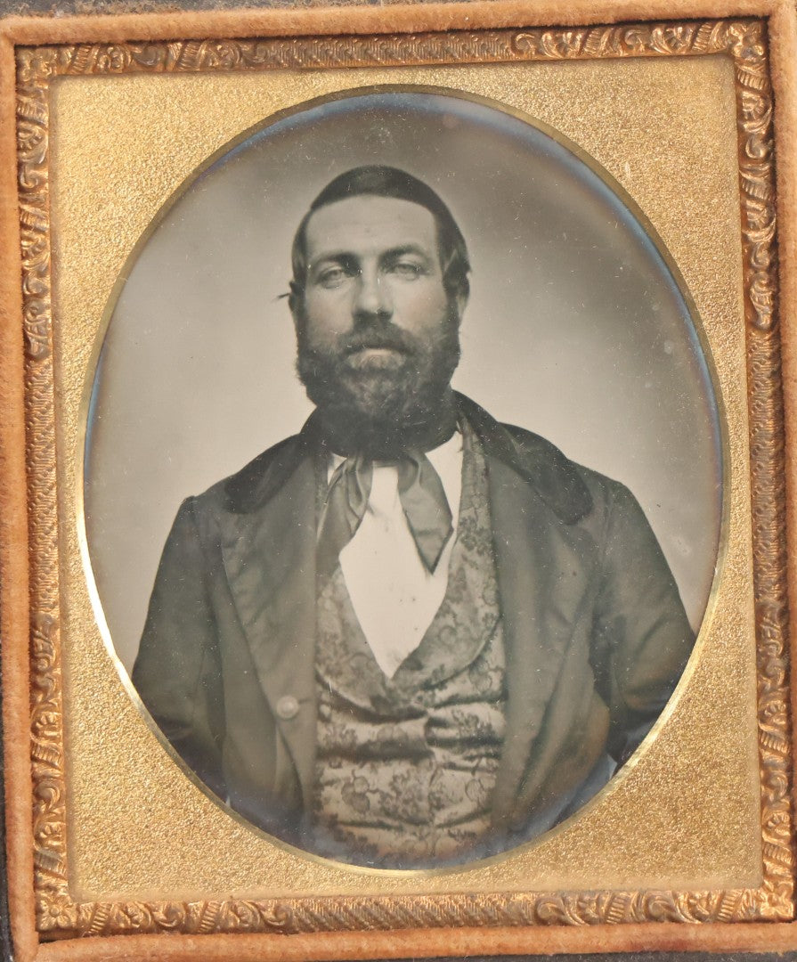 Lot 057 - Antique 1/6th Plate Ambrotype Photograph Of Bearded Man In Silk Neck Tie And Formal Dress, In Full Leatherette Union Case Repaired With Tape Hinge
