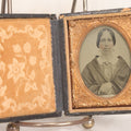 Lot 058 - Antique 1/9th Plate Hand-Tinted Ambrotype Photograph Of Woman With Shawl And Jewelry, In Full Leatherette Union Case Repaired With Taped Hinge