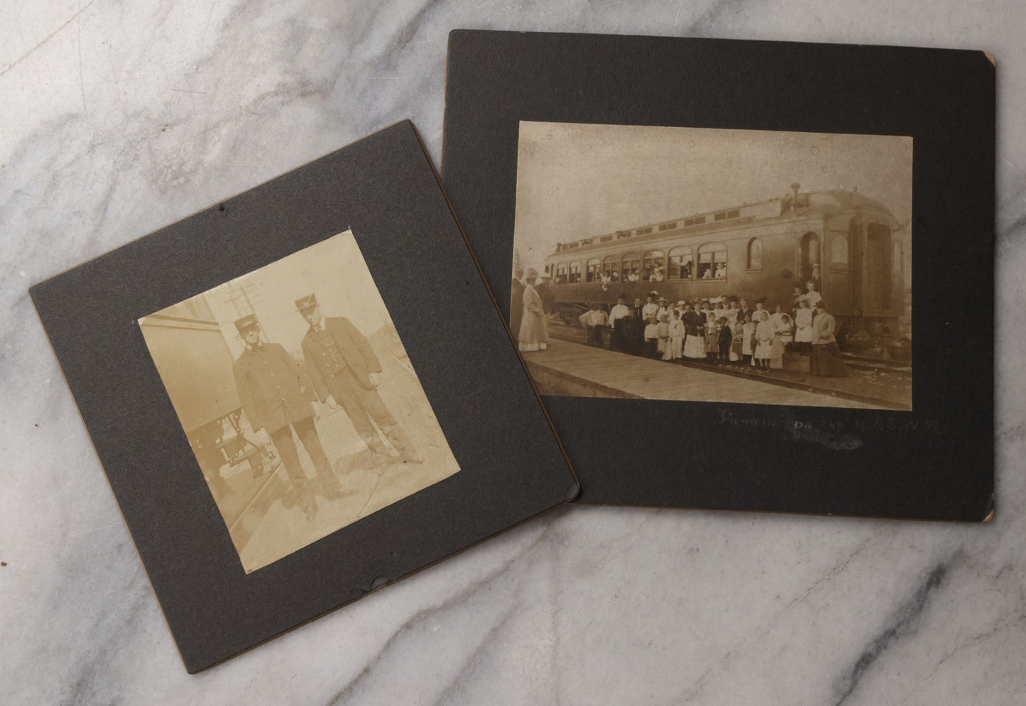 Lot 080 - Pair Of Antique Boarded Photographs Including Passengers Posing Beside Train Car With Handwritten Caption Referring To A Picnic, And Two Railroad Conductors Or Ticket Takers In Uniform